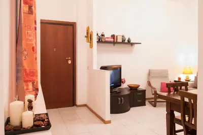 a living room with a television and a dining room at Casa Gaby in Rome