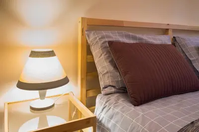 a lamp on a glass table next to a bed at Casa Gaby in Rome