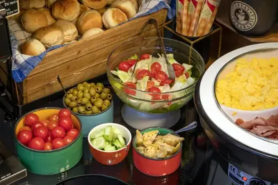 a table topped with bowls of vegetables and other food at Navona Colors Hotel in Rome