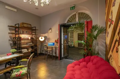 a living room with a red couch and a table at Navona Colors Hotel in Rome