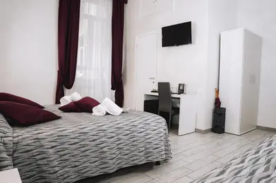 a bedroom with a bed with a desk and a television at 47 Steps in Rome