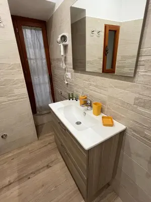 a bathroom with a sink and a mirror at Ottaviano Lodge in Rome