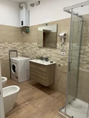 a bathroom with a toilet and a sink and a shower at Ottaviano Lodge in Rome