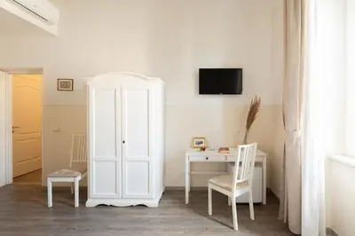 a room with a white cabinet and a desk at Dante's in Vaticano 2 in Rome