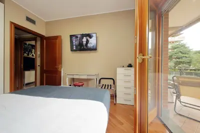 a bedroom with a bed and a balcony at Aurelia Relax Apartment in Rome