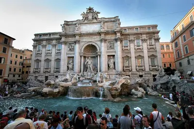 a crowd of people standing around a fountain in front of a building at Termini Palace Guesthouse in Rome