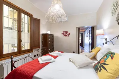 a bedroom with a large white bed with a red blanket at Rome As You Feel - Cancelleria Apartment in Navona in Rome