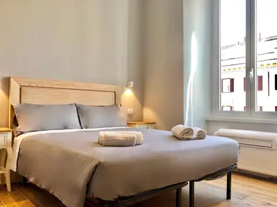 a bedroom with a bed with two towels on it at Audrey's Roman Holidays - Rome Suites & Rooms in Rome