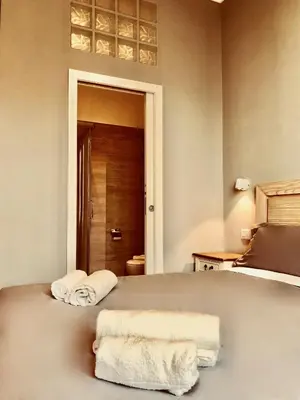 a bedroom with a bed with towels on it at Audrey's Roman Holidays - Rome Suites & Rooms in Rome