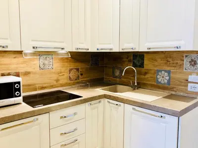 a kitchen with white cabinets and a sink and a microwave at Audrey's Roman Holidays - Rome Suites & Rooms in Rome