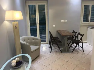 a living room with a couch and a table and chairs at Bakirooms in Rome