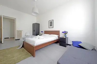 a bedroom with a large bed and a couch at Triumph Apartment in Rome
