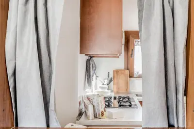 a kitchen with a stove top oven next to a window at My San Pietro Home, Vaticano in Rome