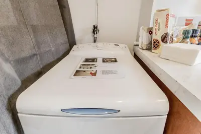 a white toilet sitting next to a counter at My San Pietro Home, Vaticano in Rome