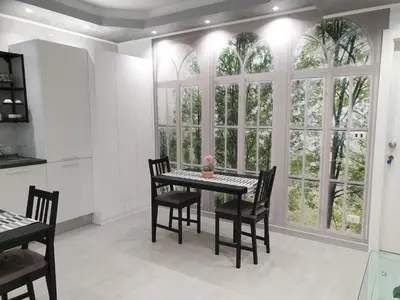 a dining room with a table and chairs and windows at Olympic Suite Roma in Rome
