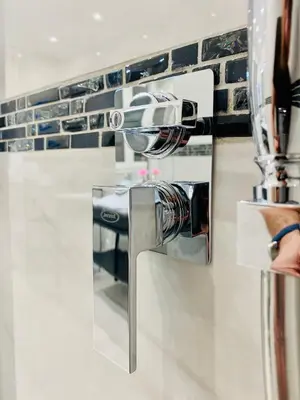a person is holding a hair dryer in a counter at Olympic Suite Roma in Rome