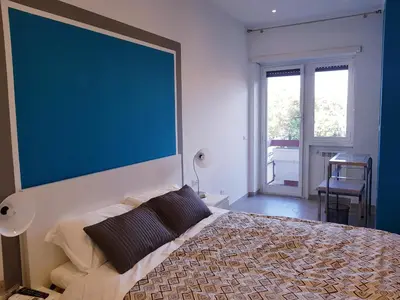 a bedroom with a large blue wall above a bed at In Rome Trastevere Rooms in Rome