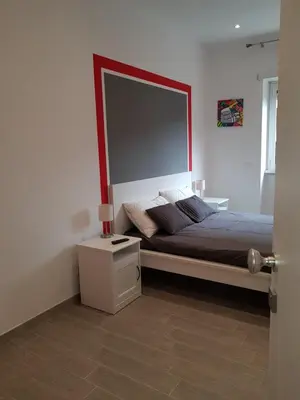 a bedroom with a bed with a large mirror above it at In Rome Trastevere Rooms in Rome
