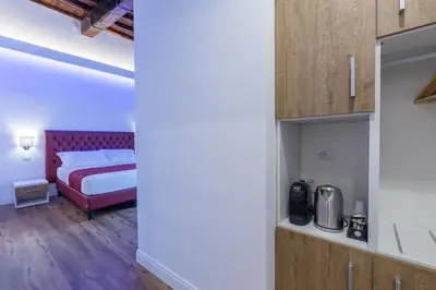 a small bedroom with a bed and a closet at Magenta Luxury Argentina in Rome
