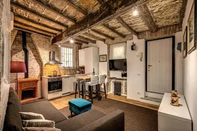 a living room with a couch and a kitchen at Farnese House in Rome in Rome
