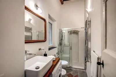 a bathroom with a sink and a toilet and a mirror at Farnese House in Rome in Rome