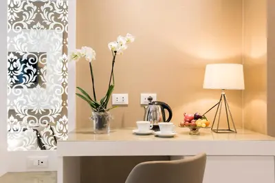 a table with a vase of flowers and a lamp at Residenza Venti Settembre in Rome