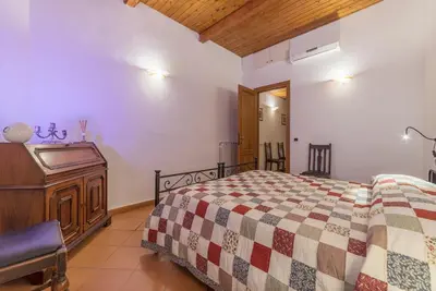 a bedroom with a bed and a dresser at GuestHost - Elegant Apartment in Rome in Rome