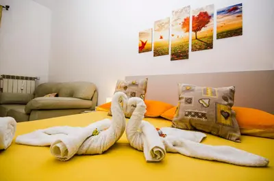 a bed with two swans made out of towels at Hello Rose - Appartamento intero in Rome
