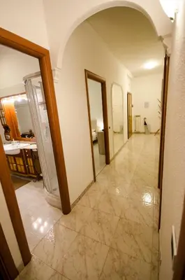 a hallway of a house with an archway and a room at Hello Rose - Appartamento intero in Rome