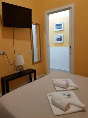 a bedroom with a bed with a flat screen tv at My Trevi Rooms 88 in Rome