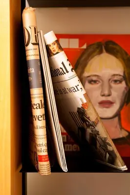 two books sitting on a shelf next to a painting at Residenza Pantaleo in Rome
