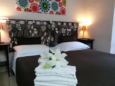 a bedroom with a bed with white towels on it at San Lorenzo Rooms in Rome