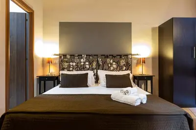 a bedroom with a large bed with towels on it at San Lorenzo Rooms in Rome