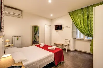 a bedroom with a bed with a red blanket at Guest House o Affittacamere La Civetta di Trastevere B in Rome