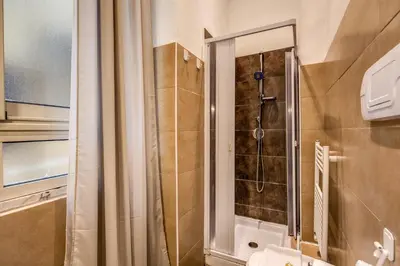 a bathroom with a shower with a glass door at Guest House o Affittacamere La Civetta di Trastevere B in Rome