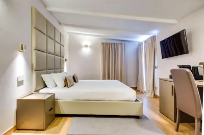 a hotel room with a bed and a desk at V Collection Relais Badoer in Rome