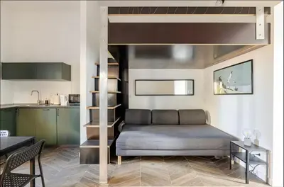 a bedroom with a loft bed and a kitchen at Rome Apartment San Pietro - Monte del Gallo in Rome