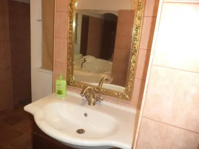 a bathroom with a sink and a mirror at Jacuzzi Quo Vadis in Rome