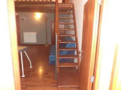 a room with a ladder leading to a bunk bed at Jacuzzi Quo Vadis in Rome