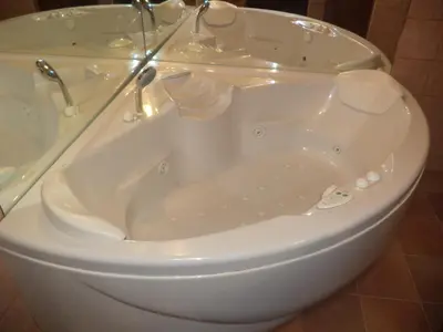 a white toilet with a tub in a bathroom at Jacuzzi Quo Vadis in Rome