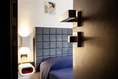 a room with a bed in a room with a wall at Old Kitchen Vatican Suites in Rome