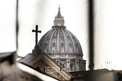 a cross on top of the dome of a building at Old Kitchen Vatican Suites in Rome