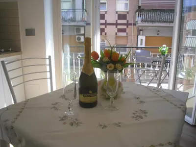 a table with a bottle of wine and two wine glasses at Lovely Little Apartment in Via Aurelia in Rome