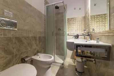 a bathroom with a toilet and a sink and a shower at Residenza Sistina in Rome