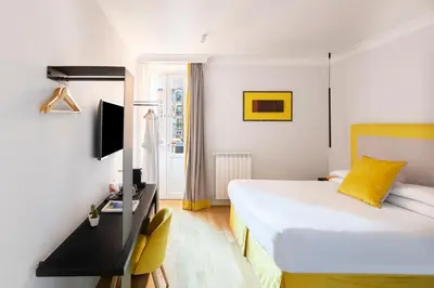 a hotel room with a bed and a desk and a television at Residenza Palline by Hili in Rome