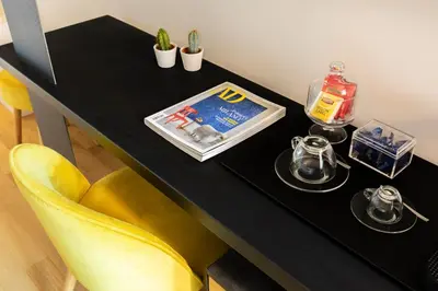 a black table with a yellow chair and a black table at Residenza Palline by Hili in Rome