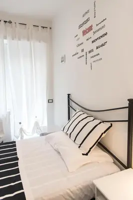 a bedroom with a bed and a wall with words on it at Eden guest house in Rome