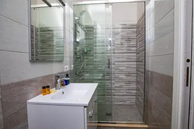 a bathroom with a sink and a glass shower at Your Secret Pantheon in Rome