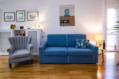 a blue couch and a chair in a living room at Your Secret Pantheon in Rome