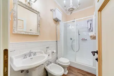 a bathroom with a sink and a toilet and a shower at Lunaria Suites Rome Vaticano in Rome